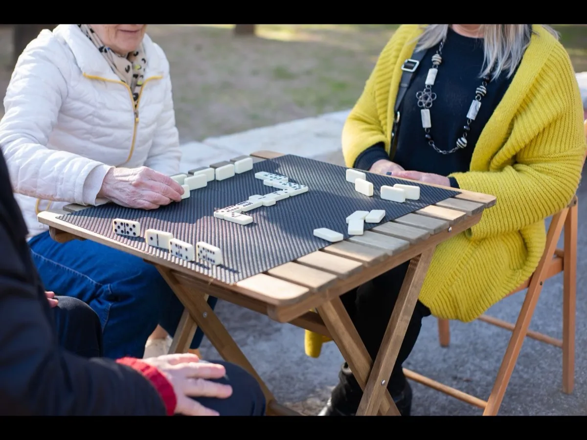 A group of adults playing a table game together